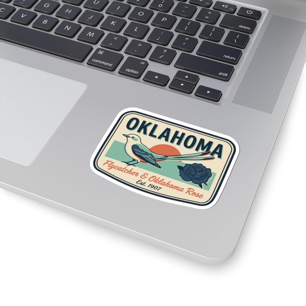 Oklahoma sticker on laptop lid, showing bird, rose, and “Est. 1907”
