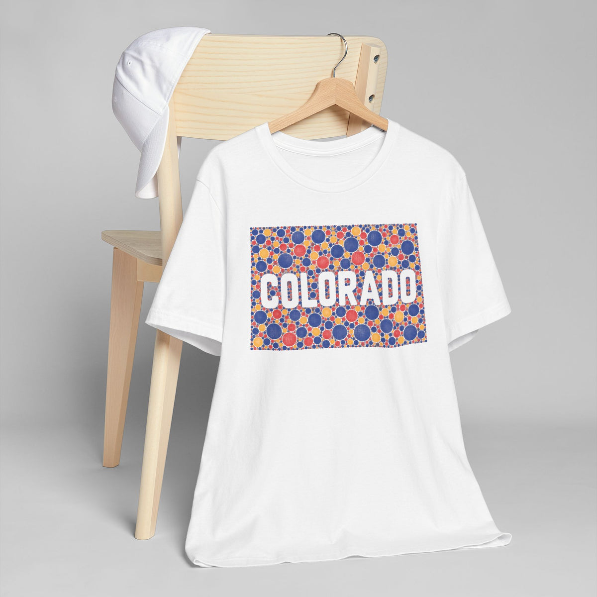 Cream crew-neck t-shirt with colorful patterned "COLORADO" graphic rectangle