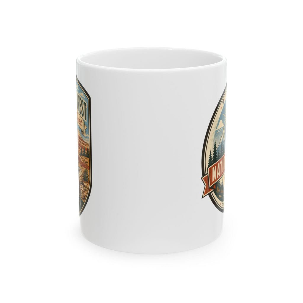 White ceramic mug with side graphic badge featuring trees and desert landscape