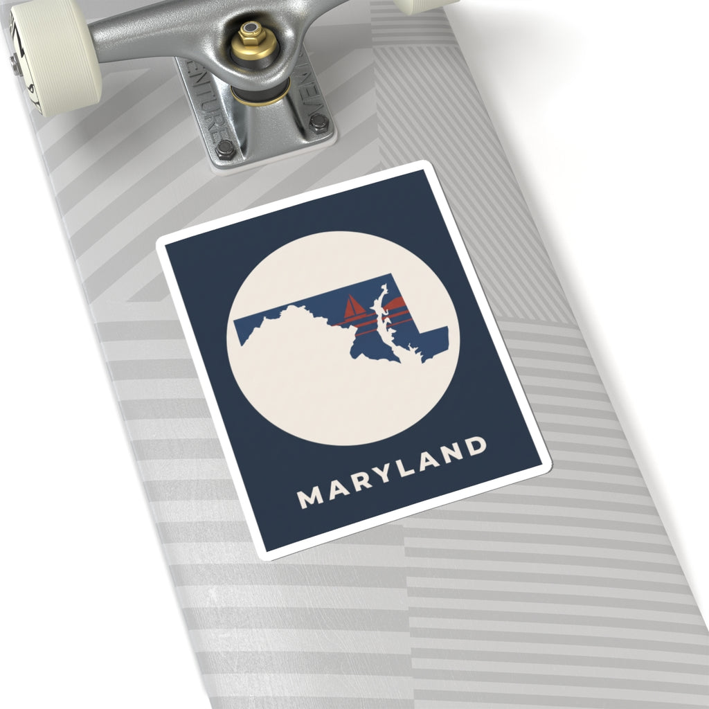 Maryland map sticker on luggage, navy square with circular state silhouette and sailboat
