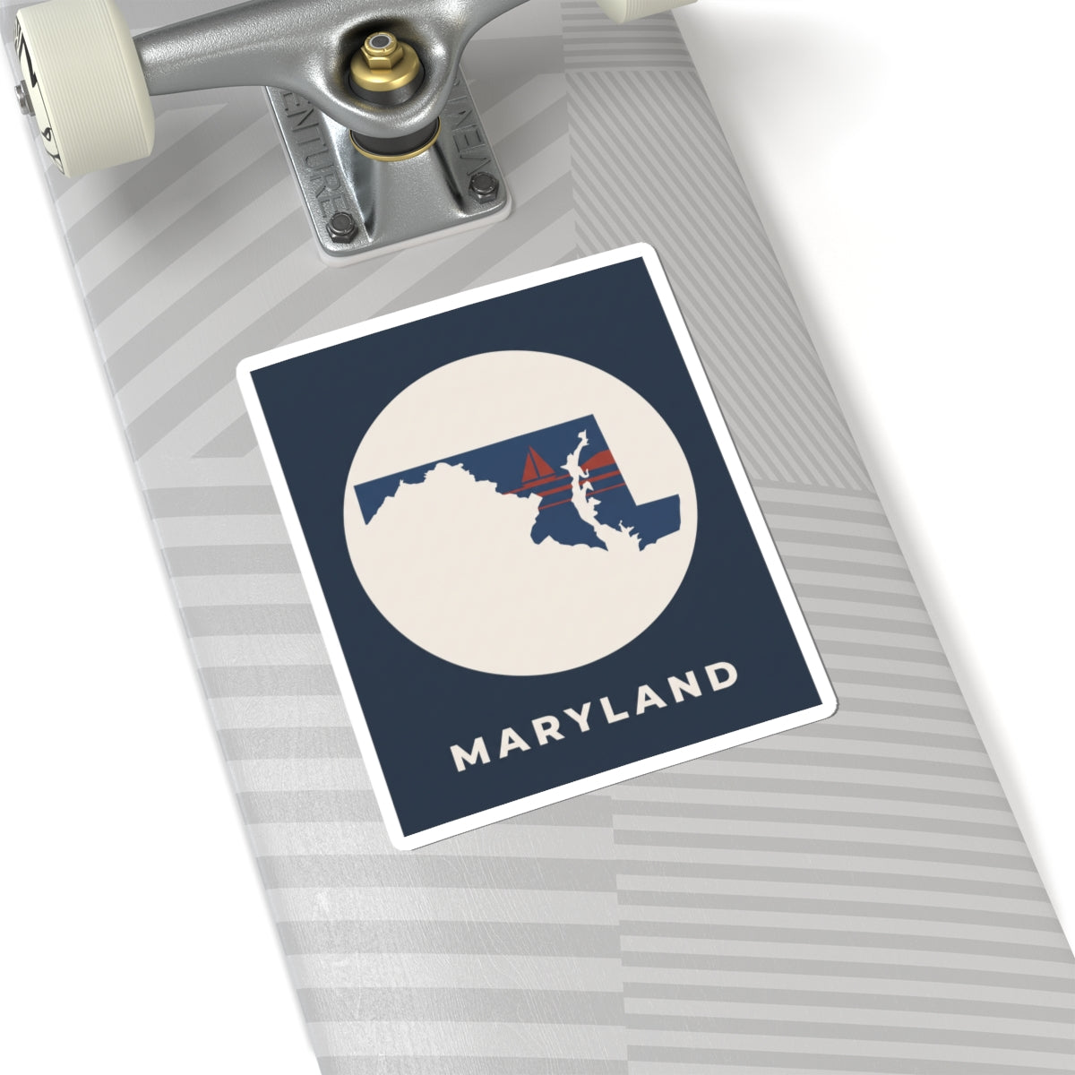 Maryland map sticker on luggage, navy square with circular state silhouette and sailboat