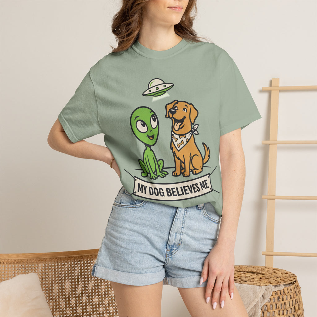 Sage green T-shirt on model with alien and dog graphic and slogan