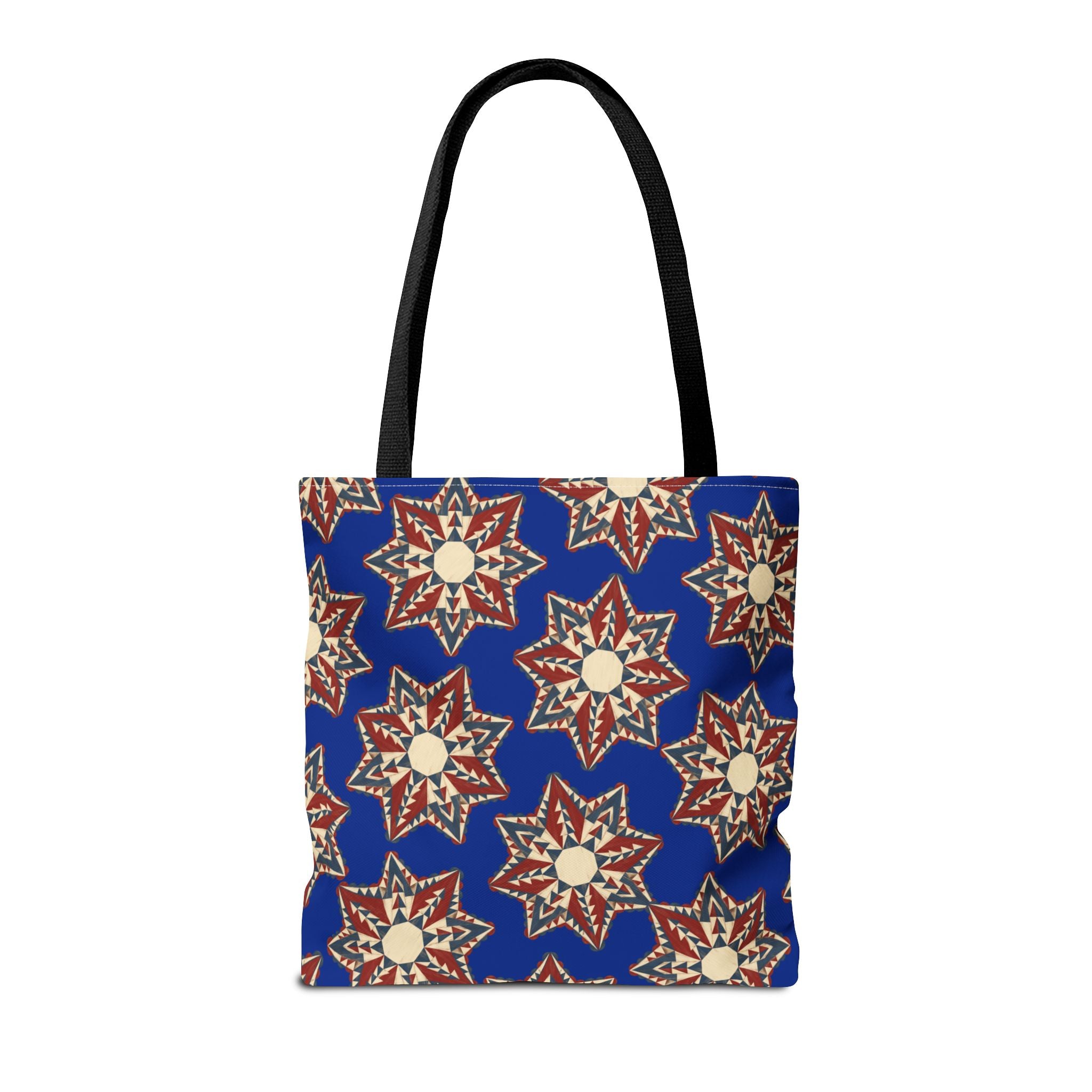 Blue tote bag with starburst floral mandala pattern and black handles, centered