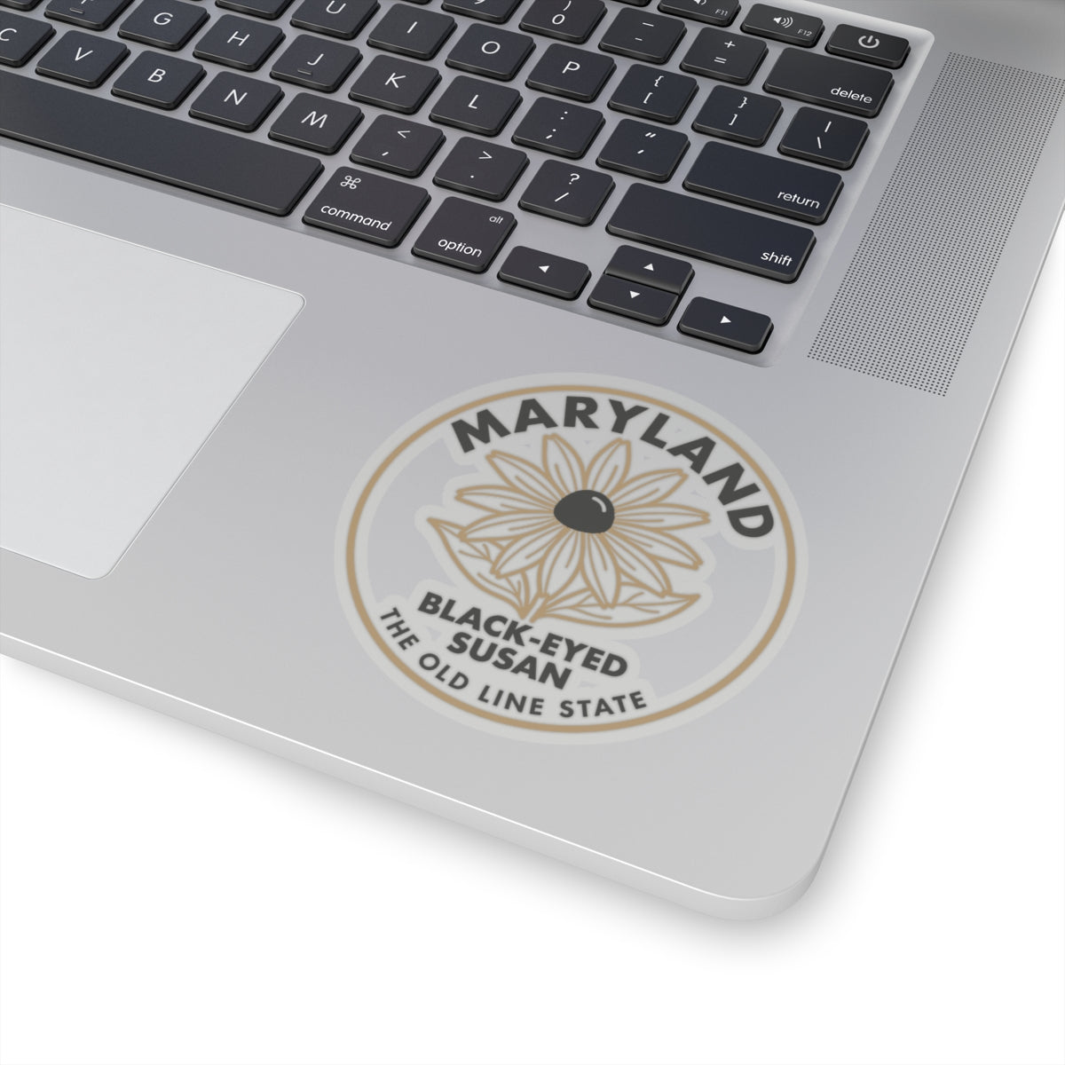 Circular Maryland black-eyed Susan sticker on laptop lid, full design with state text ring.