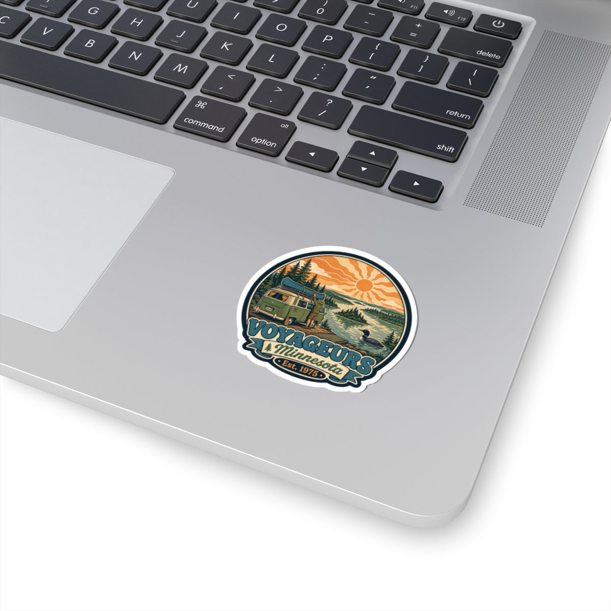Vintage Voyageurs National Park camper van sticker, circular design with orange sun and forest