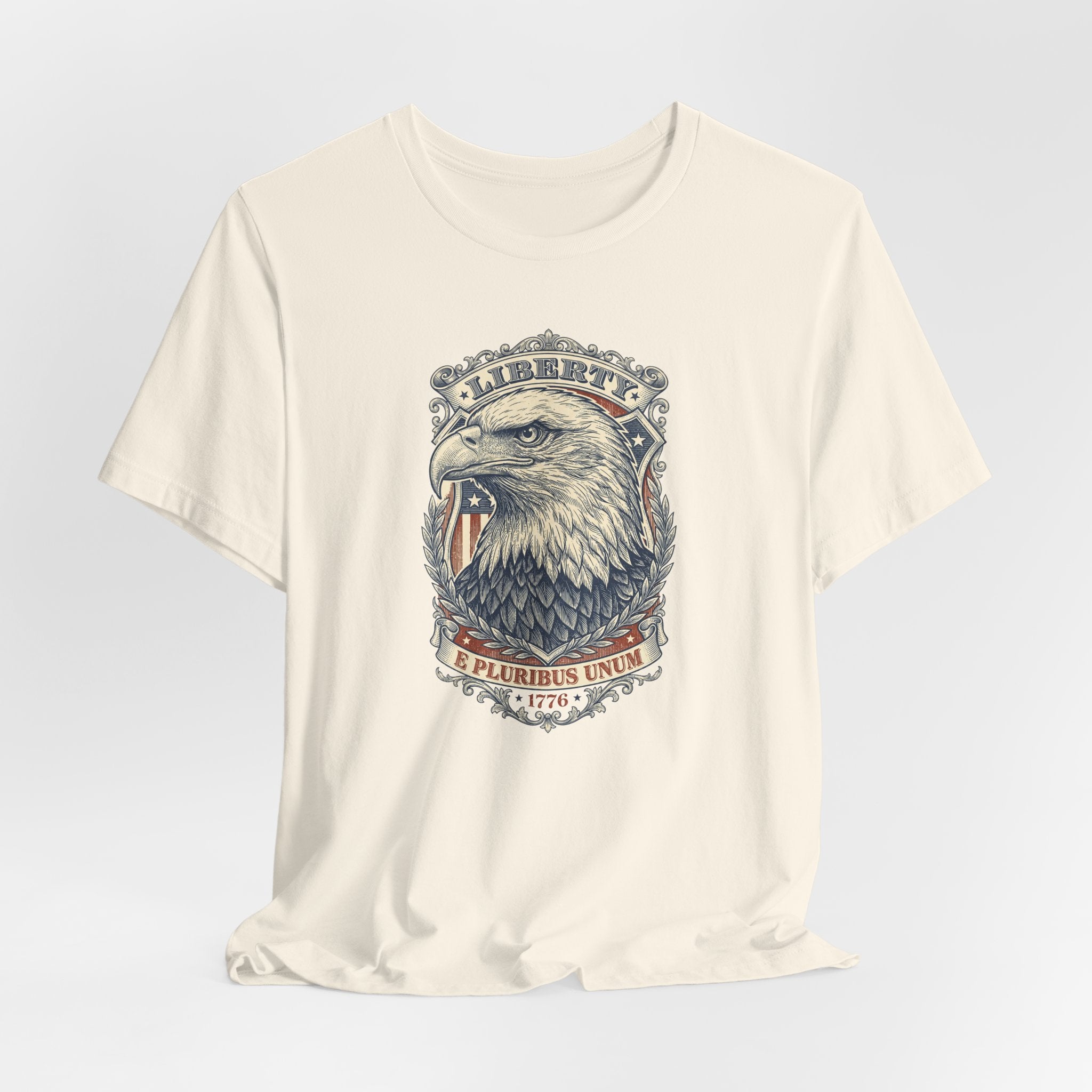 Cream crewneck tee with bald eagle head graphic and circular “E Pluribus Unum” design