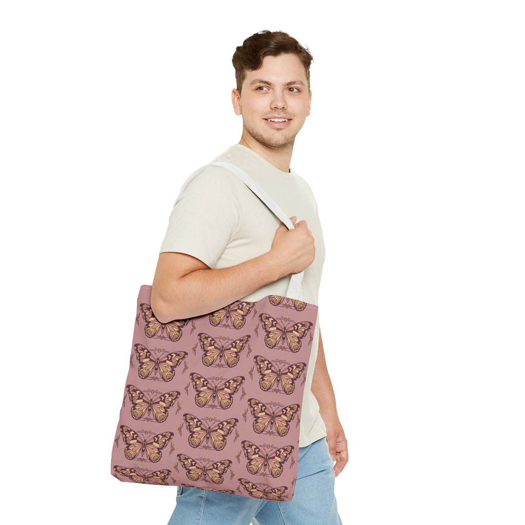 Pink butterfly print tote bag with light handles, carried across the chest.