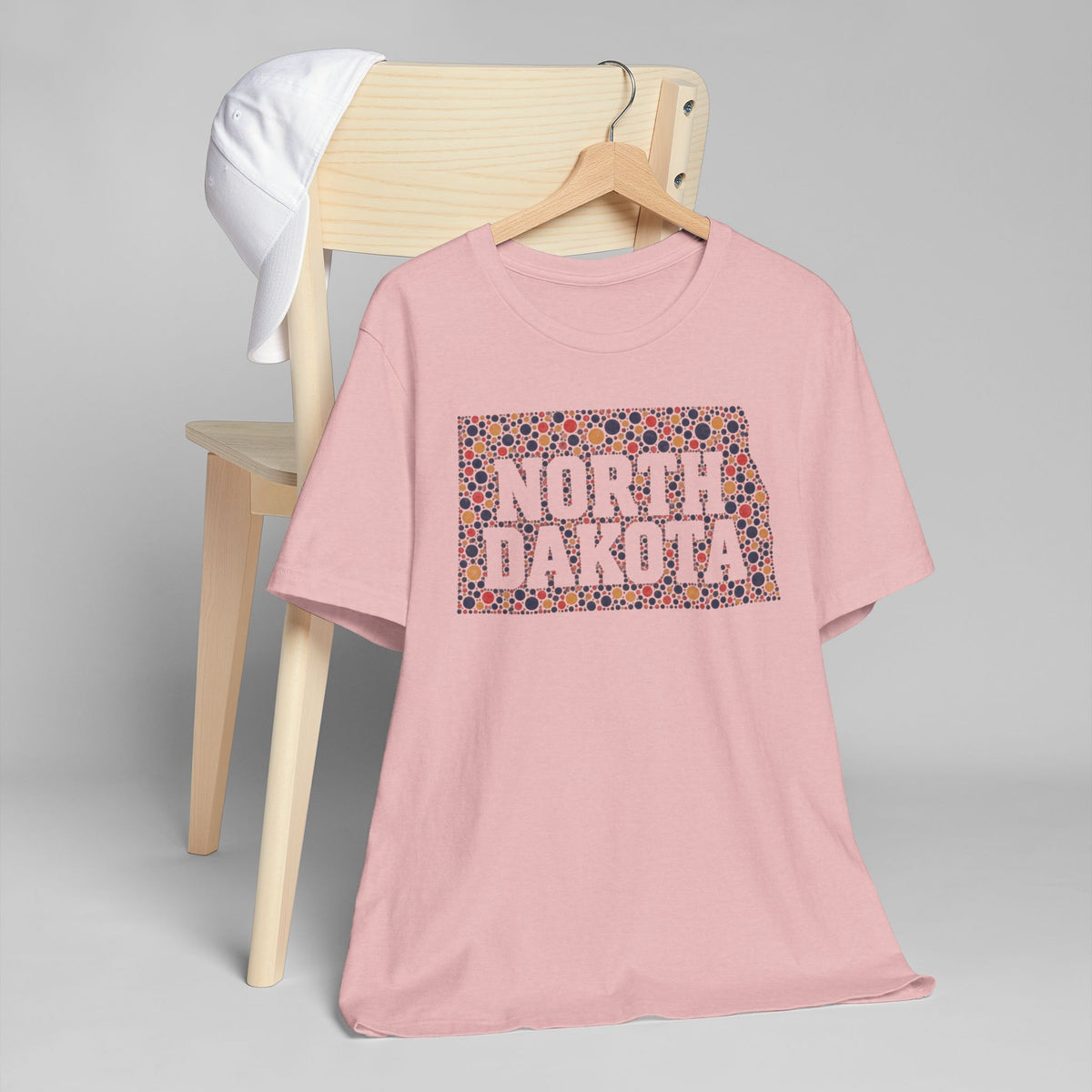 Pink graphic t-shirt with colorful North Dakota floral map front print