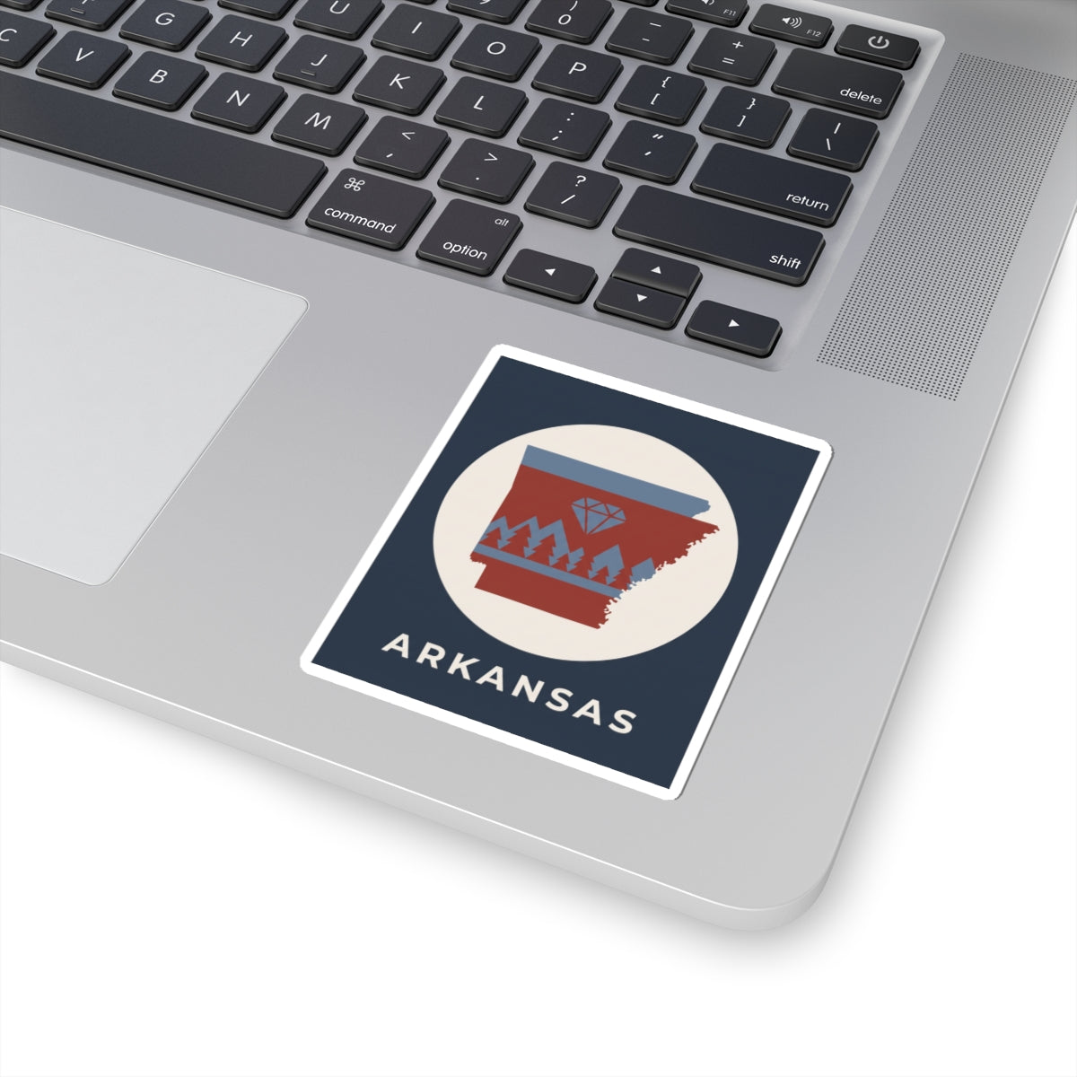 Arkansas emblem kiss-cut sticker on laptop, diamond and pine trees with ARKANSAS text