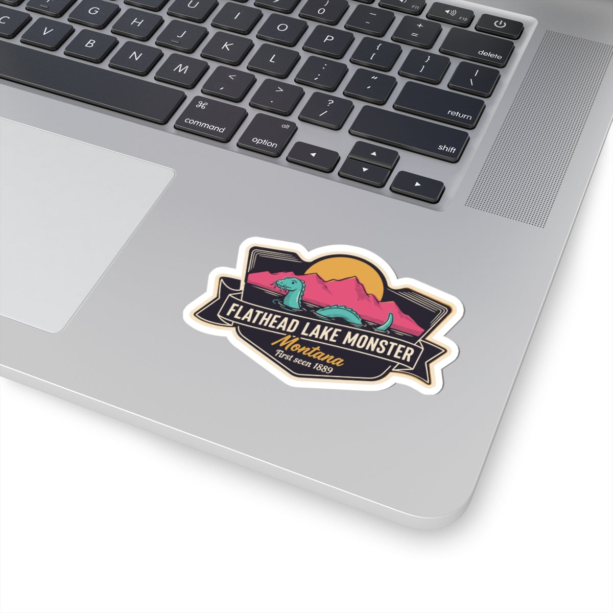 Die-cut Flathead Lake Monster sticker with teal creature and bold ribbon design