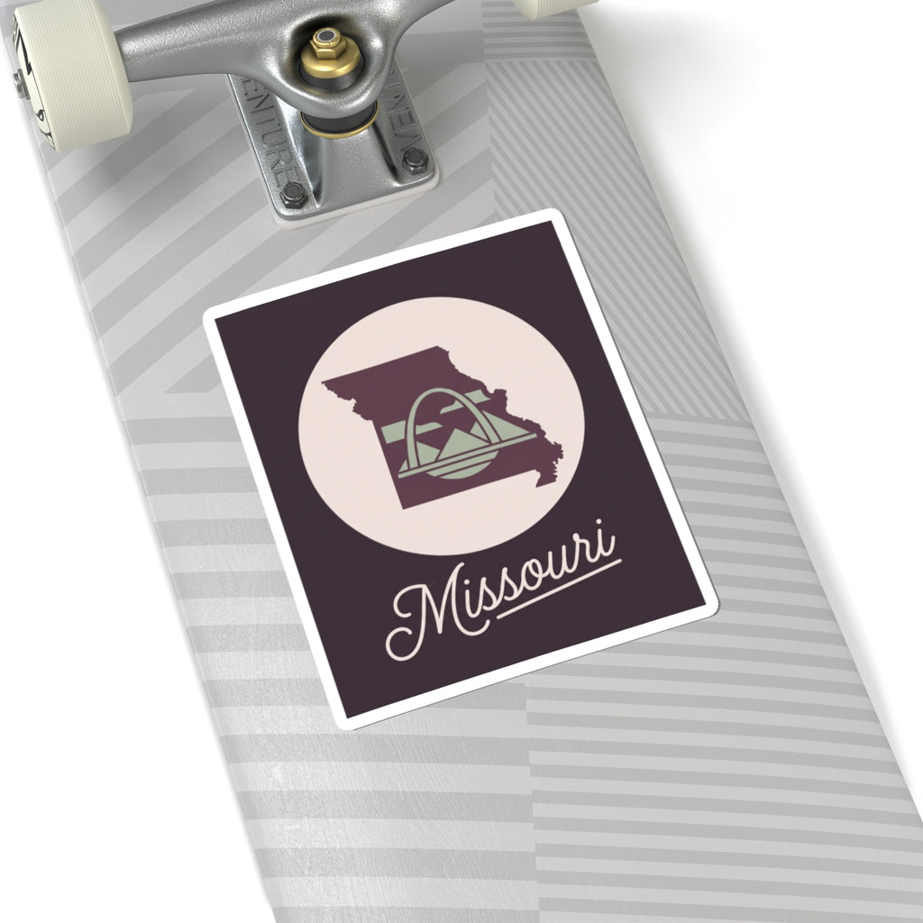 Missouri sticker decal on a surface, dark purple square with circular emblem and script
