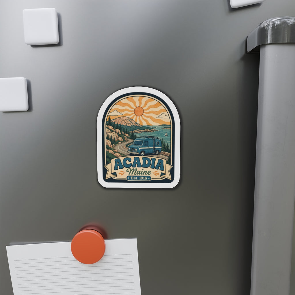 Die-cut Acadia Maine magnet on stainless fridge with coastal landscape, camper, and Est. 1916