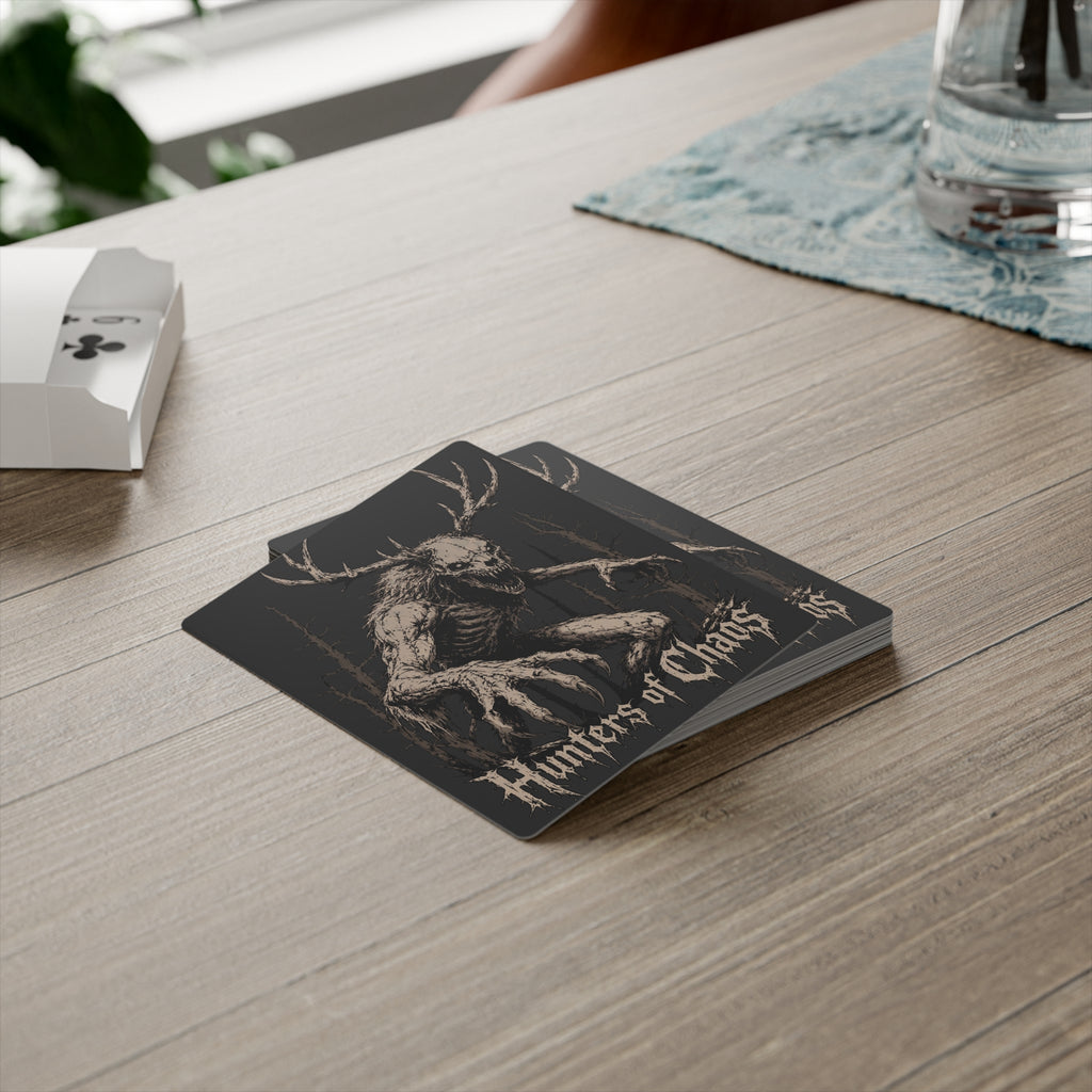 Hunters of Chaos poker card with antlered skull design near a deck box