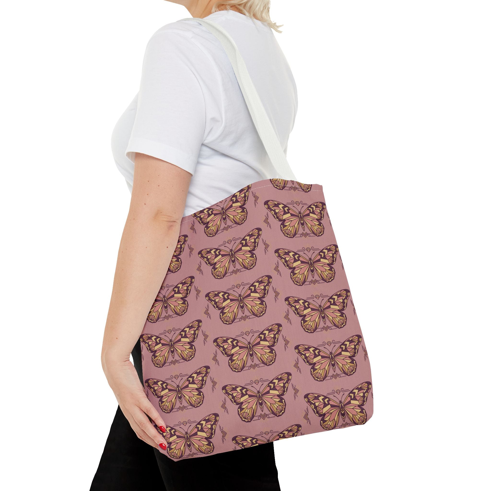 Pink butterfly print tote bag with light handles on the shoulder, back view.
