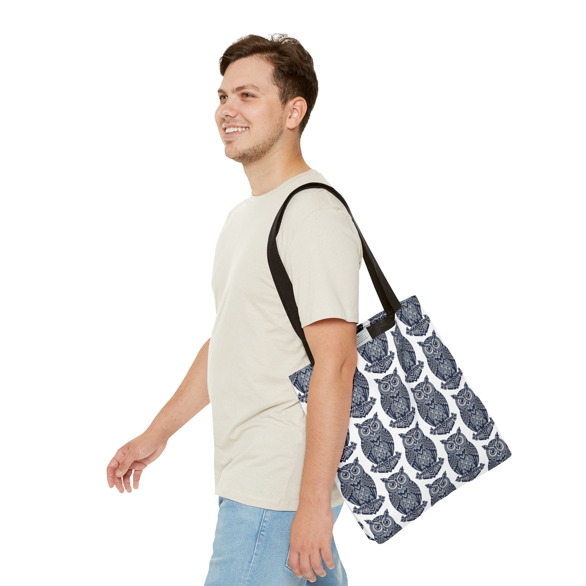 Owl print tote bag with black handles, worn over a shirt; repeating blue and white owls.