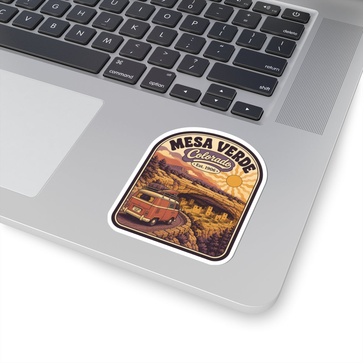 Rounded kiss-cut sticker with Mesa Verde Colorado scene and red camper van
