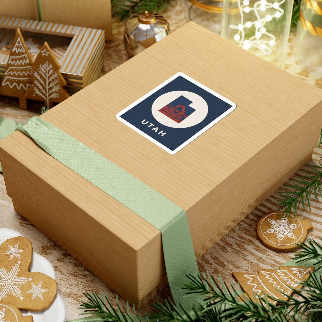 Utah arch sticker on a boxed gift: navy square with white circle, red emblem, "UTAH"