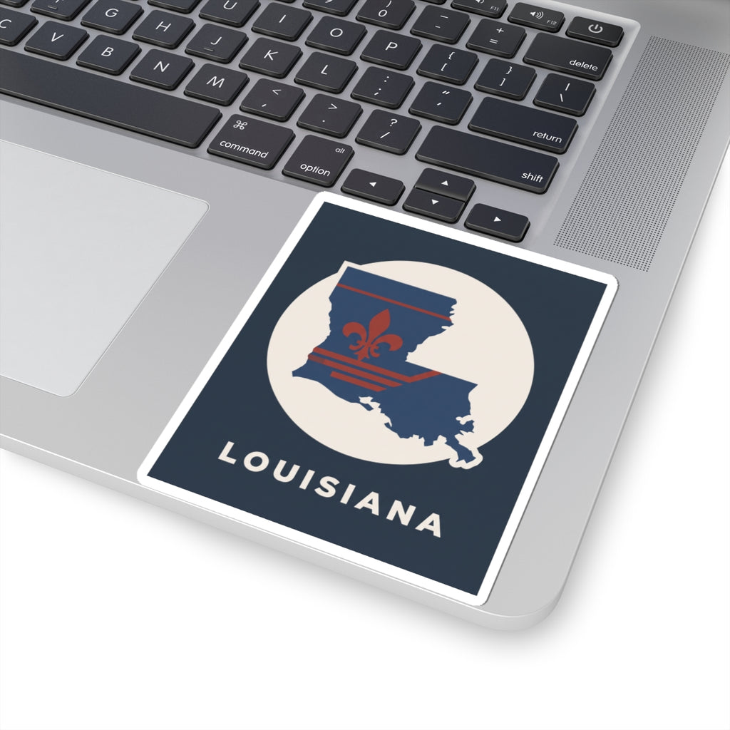 Louisiana sticker on laptop lid, blue state outline with red fleur-de-lis and cream circle