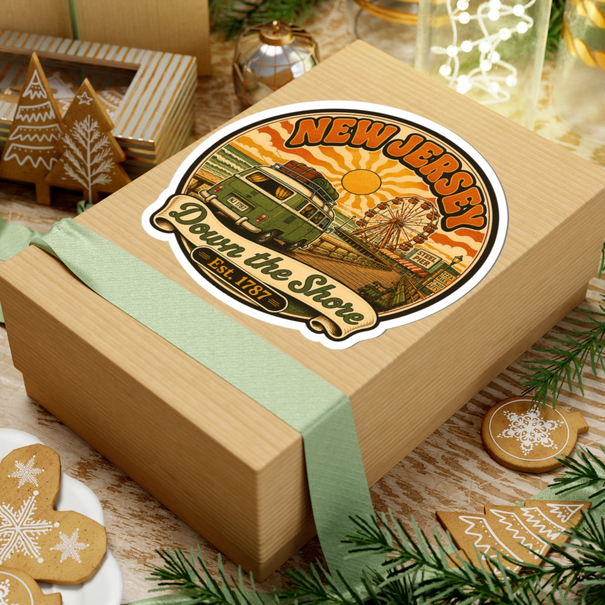 Round sticker on a wrapped gift box, featuring Down the Shore text and van by pier.