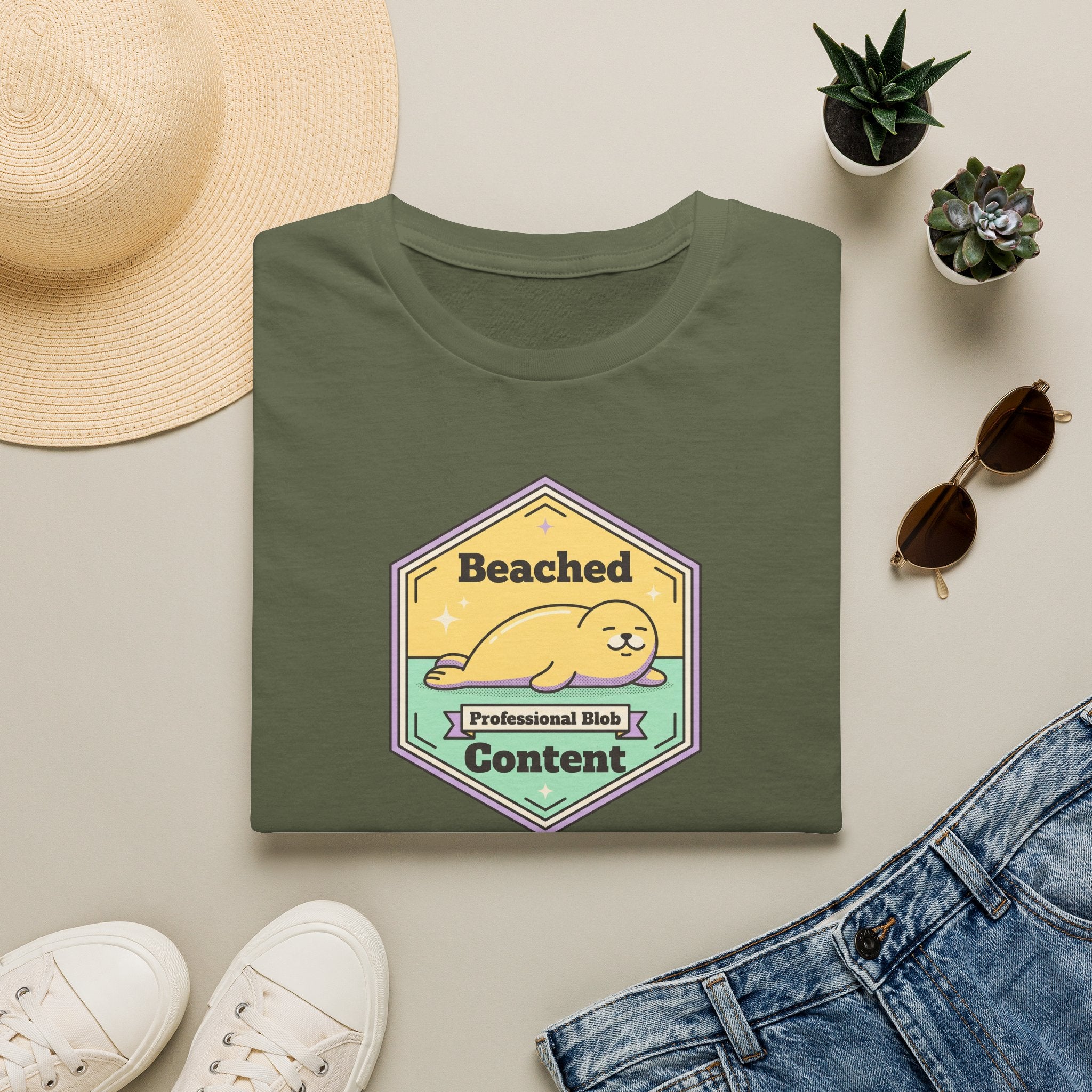 Olive green seal badge graphic T-shirt with 'Beached Content' text