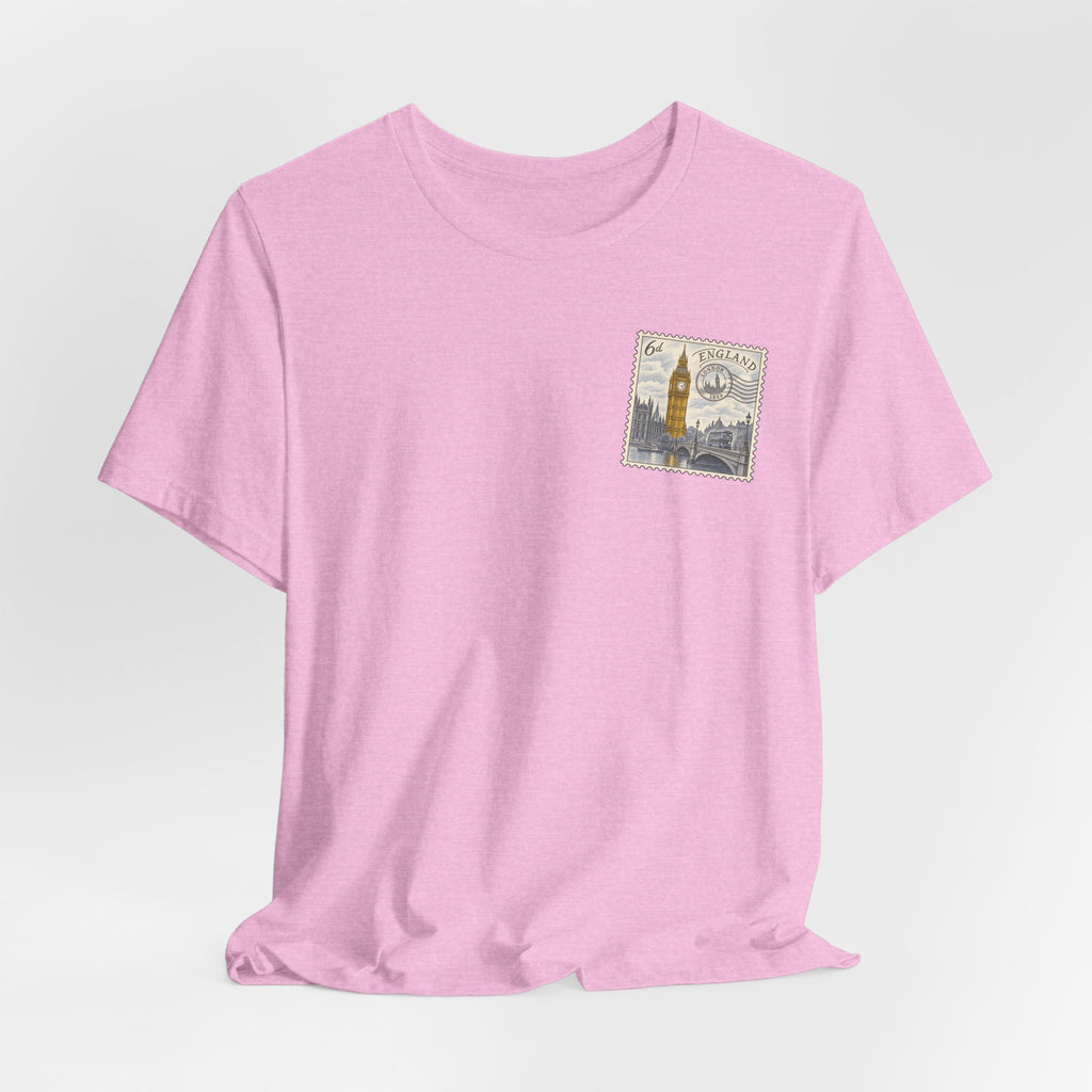 Pink T-shirt with short sleeves and a small vintage postage stamp graphic on the chest