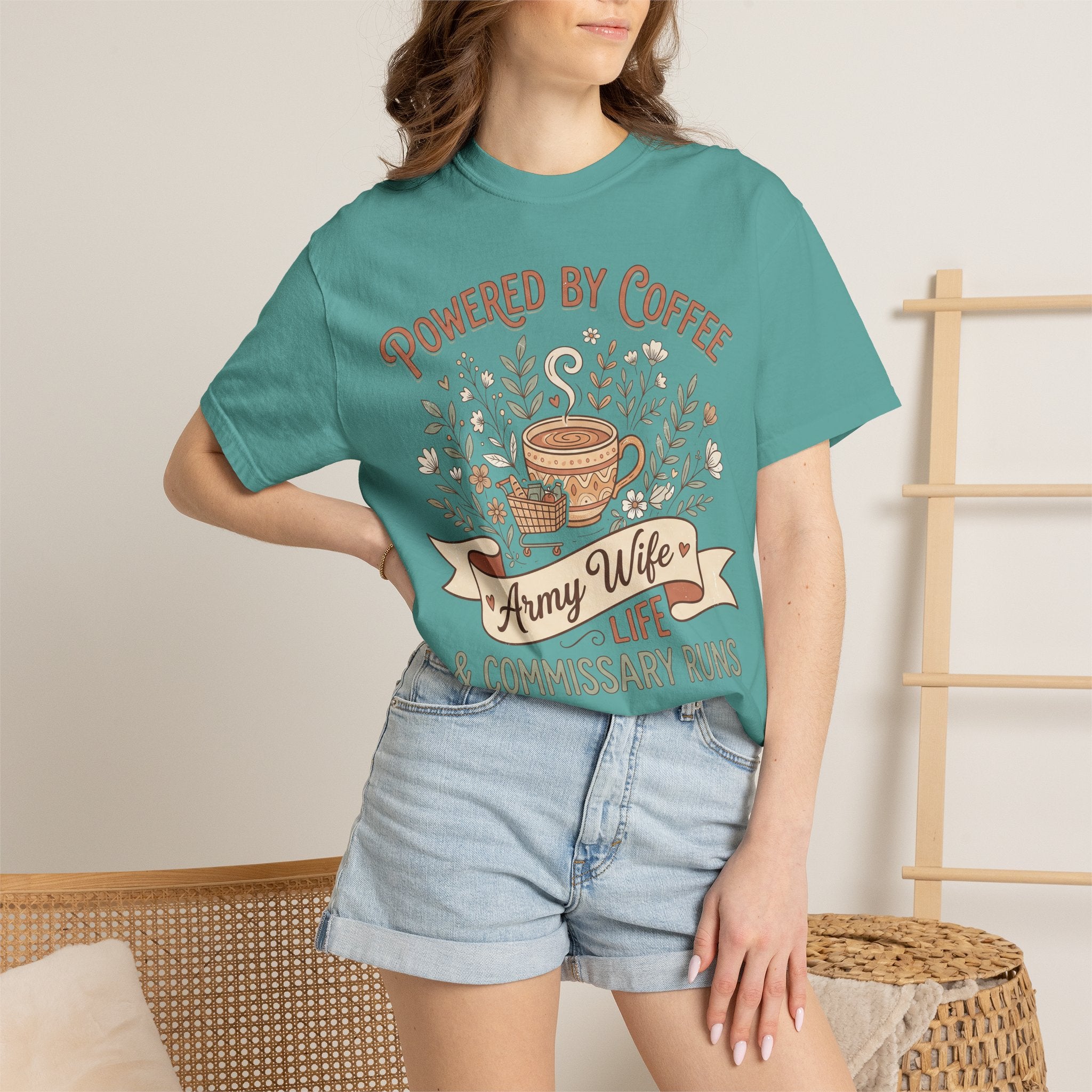 Teal T-shirt on model with Powered by Coffee graphic and coffee cup floral design