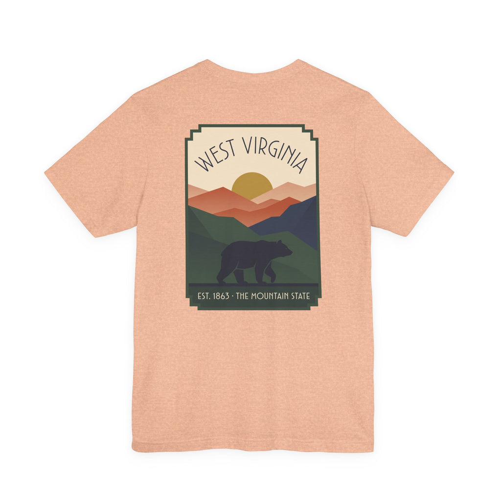Light pink T-shirt with West Virginia bear and mountain graphic on the front.