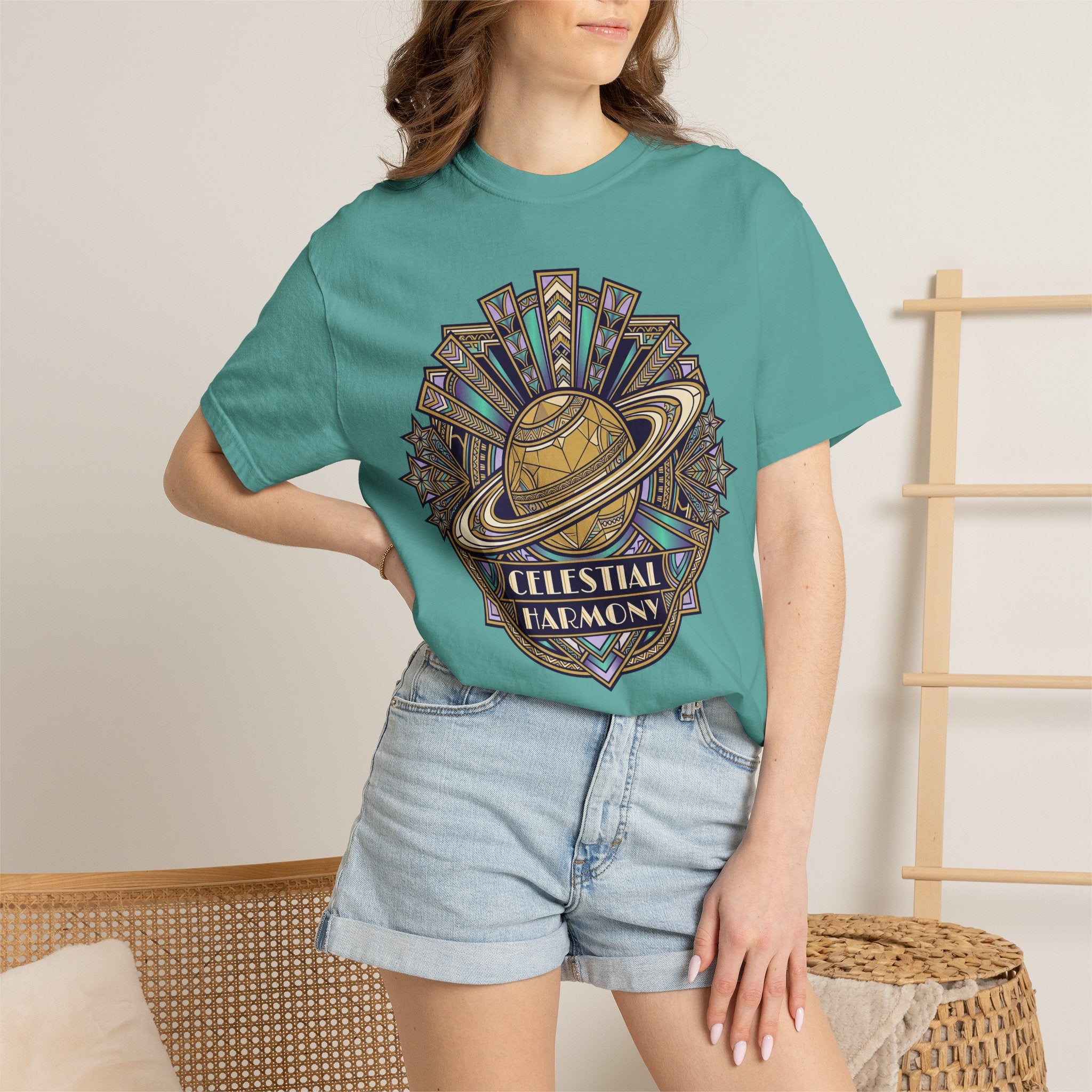 Teal T-shirt with Celestial Harmony planet graphic and text on front