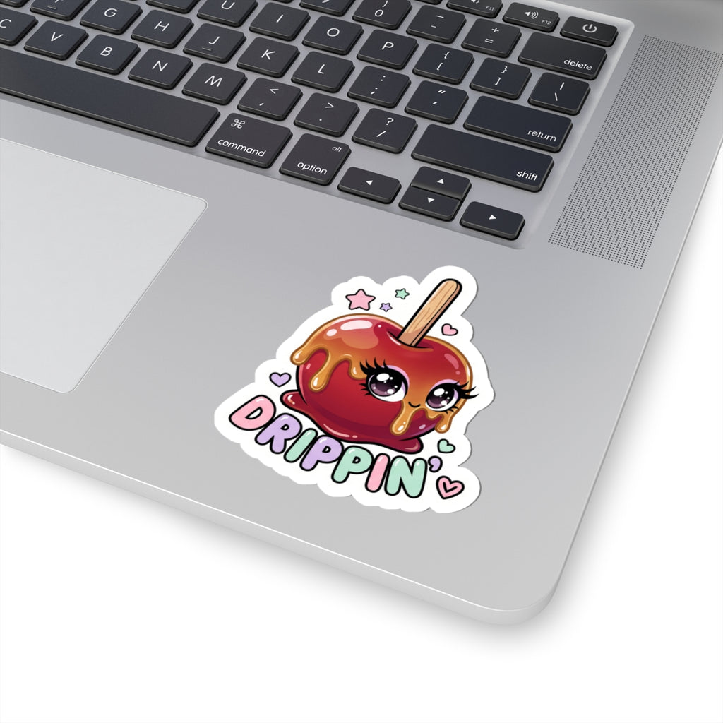 Kiss-cut sticker of a red candy apple character with "DRIPPIN'" on a laptop lid