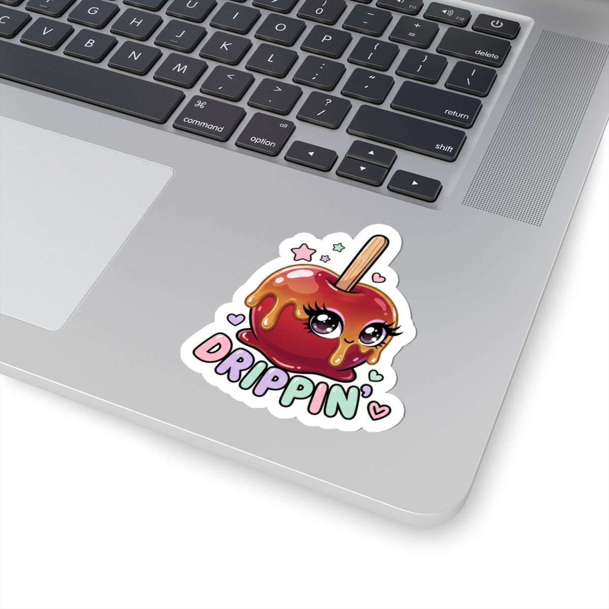Kiss-cut sticker of a red candy apple character with "DRIPPIN'" on a laptop lid