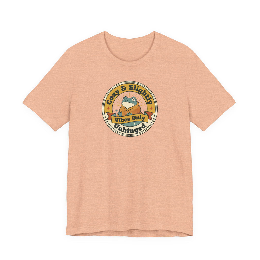 Peach sloth graphic T-shirt with round badge emblem on chest