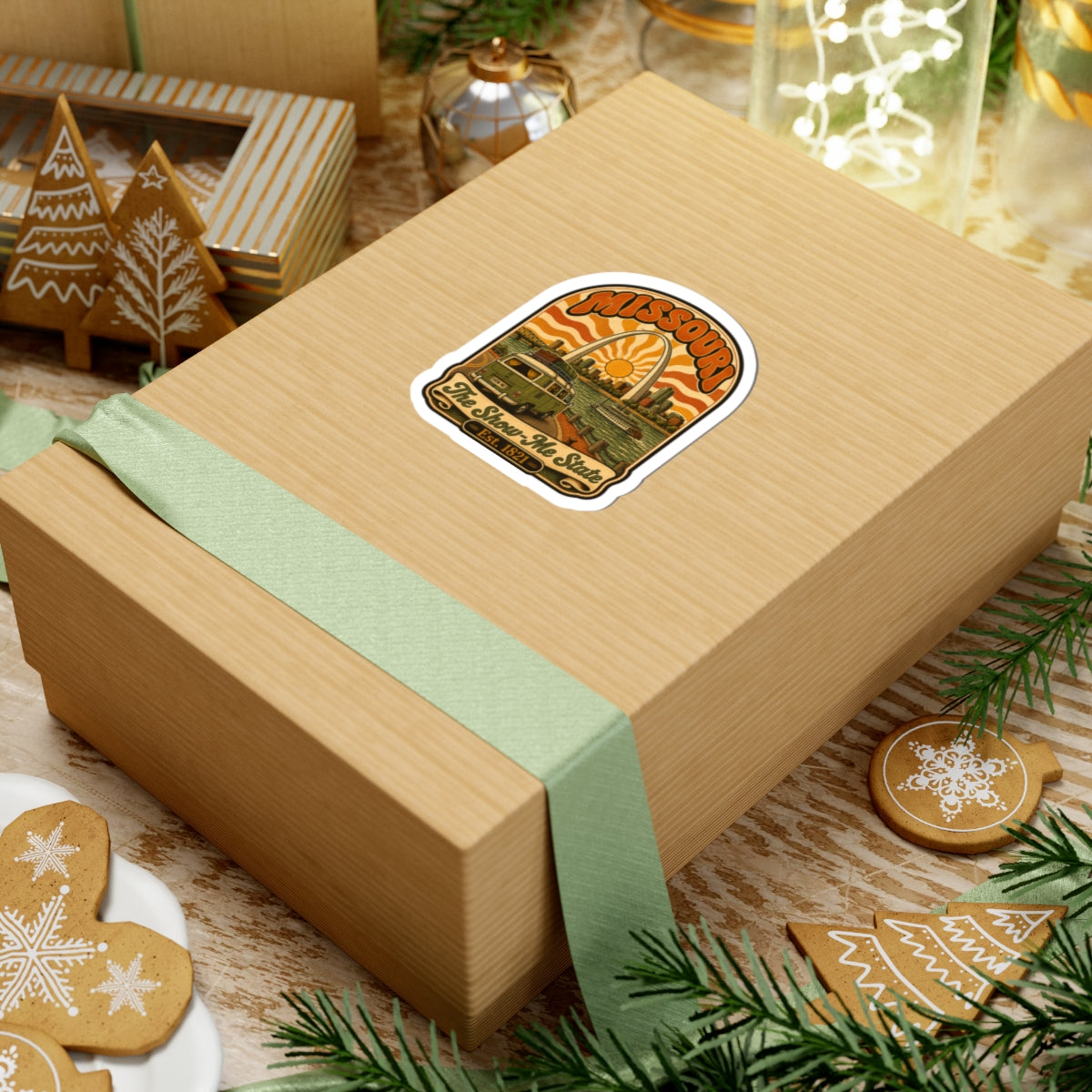 Missouri retro roadtrip sticker on a wrapped gift box, bus and riverboat under arch sun
