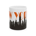 White ceramic coffee mug with orange “WYORK” text and black city skyline