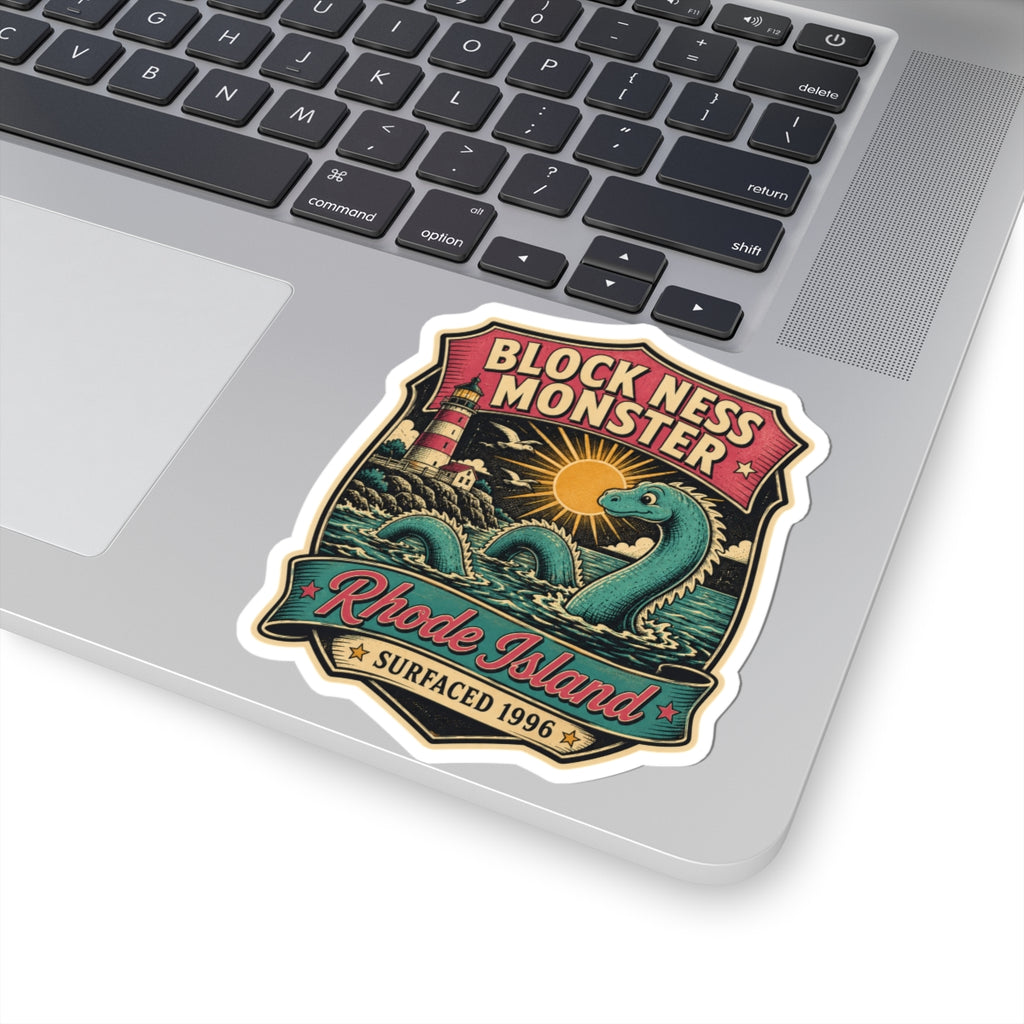 Shield-shaped vinyl sticker showing teal monster, sun over waves, and 'Rhode Island' ribbon.