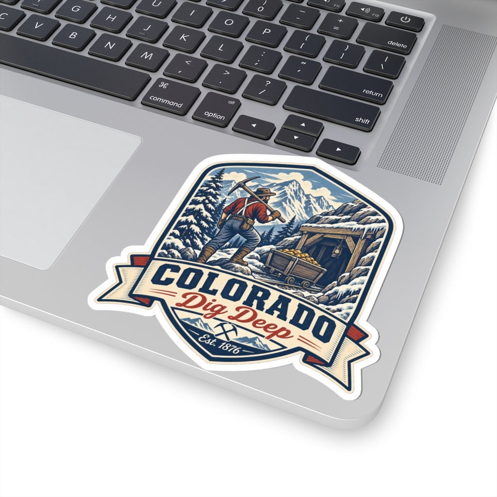 Die-cut sticker with Colorado banner and miner digging scene, snowy mountains, Est. 1876