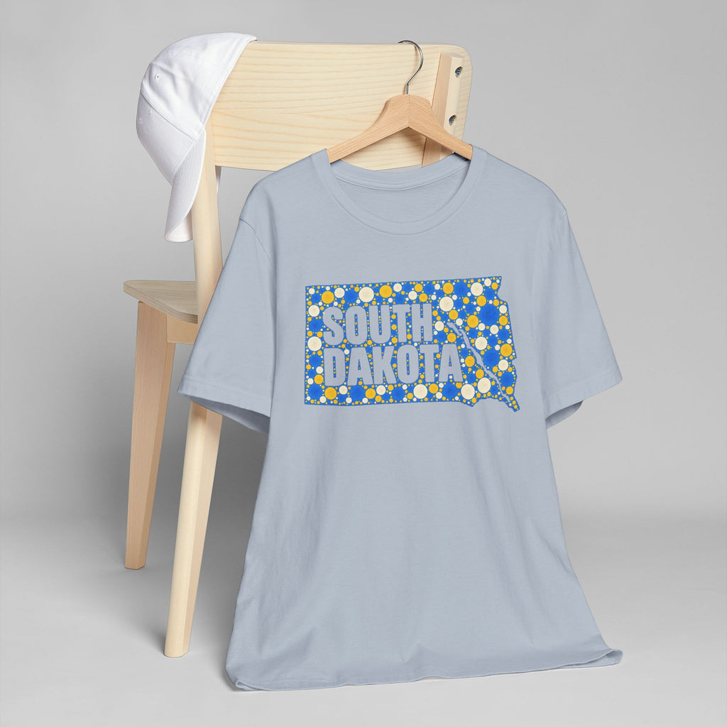 Light blue crew-neck T-shirt with blue-and-yellow South Dakota polka-dot map graphic on front