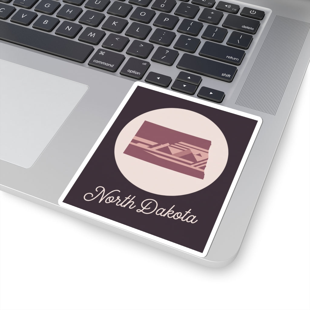 North Dakota square kiss-cut sticker featuring maroon illustrated state scene and script name