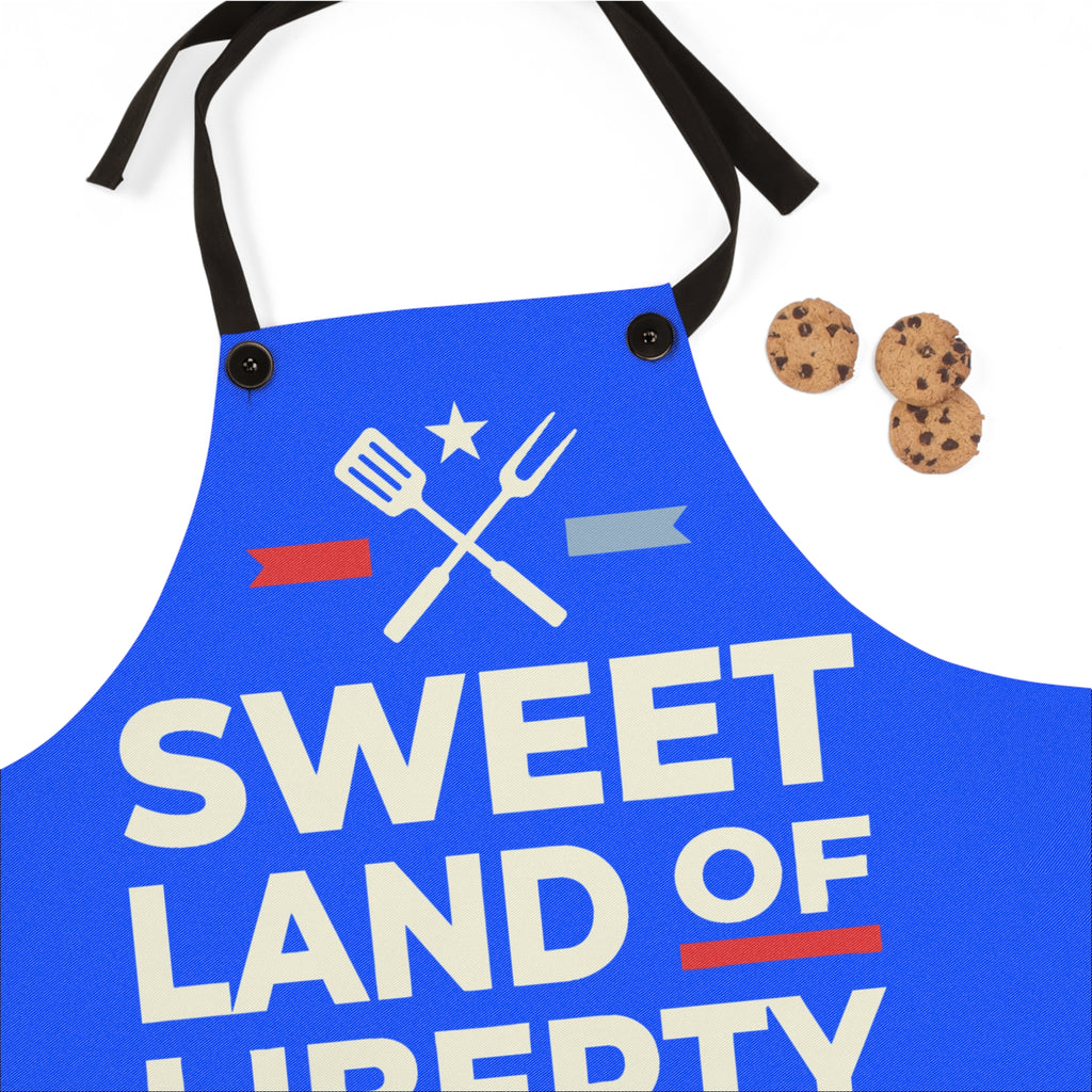 Blue BBQ apron front panel with 'SWEET LAND OF LIBERTY' text and crossed utensils