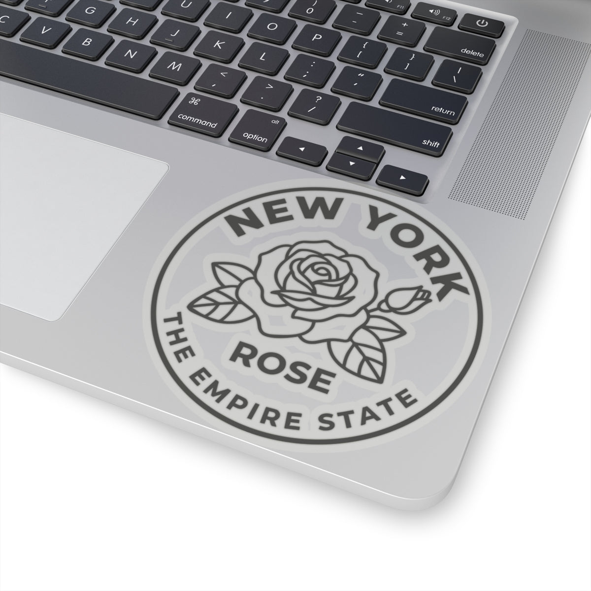 Circular gray rose state vinyl decal on laptop with “ROSE” and “THE EMPIRE STATE”