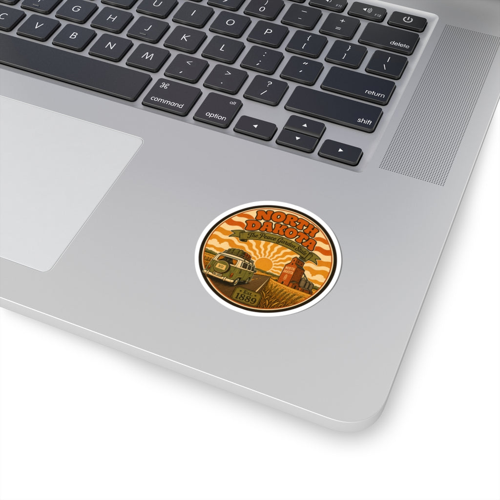 Circular North Dakota vintage travel sticker with orange retro landscape and white border