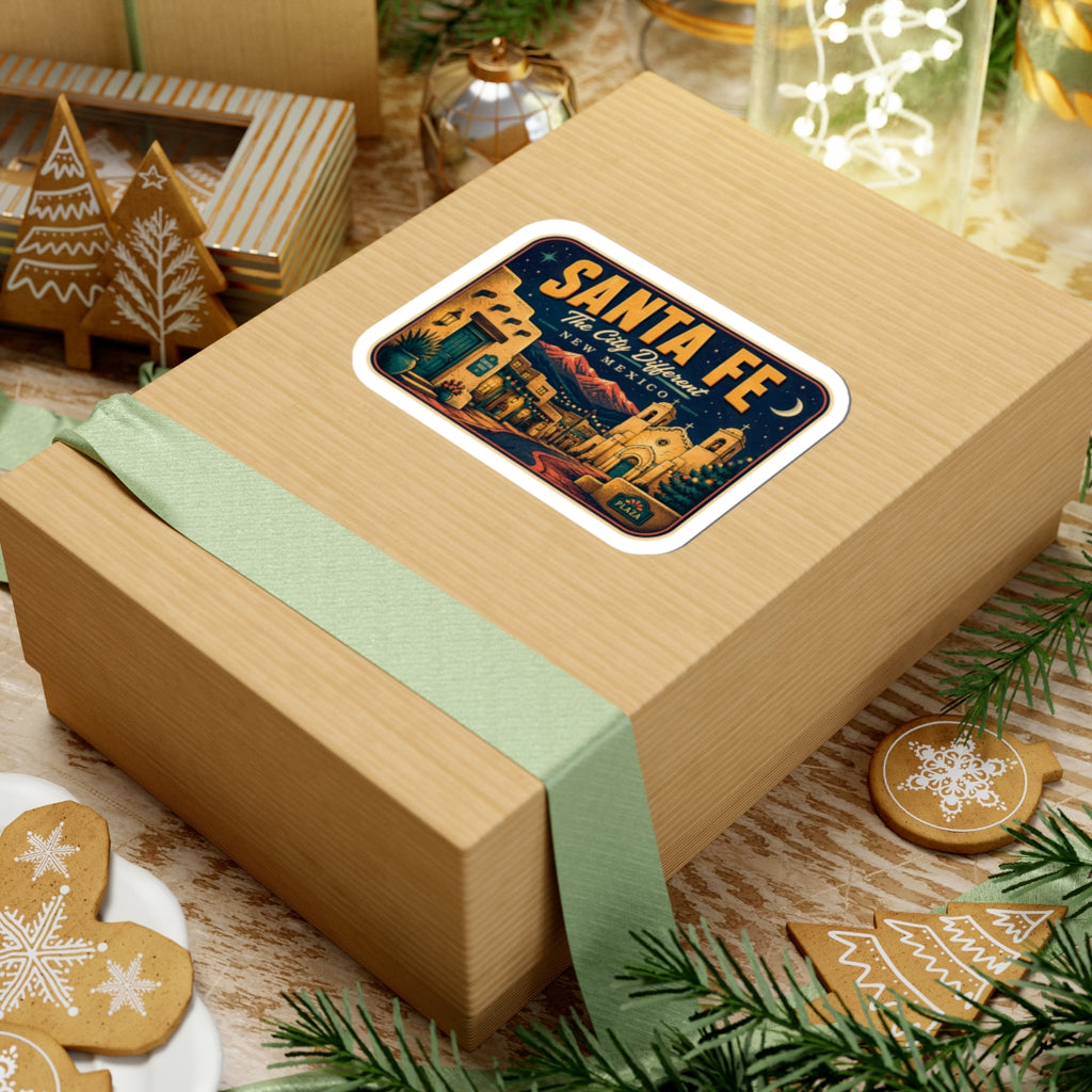 Santa Fe luggage tag sticker on a wrapped box, rectangular travel decal with “New Mexico” text.