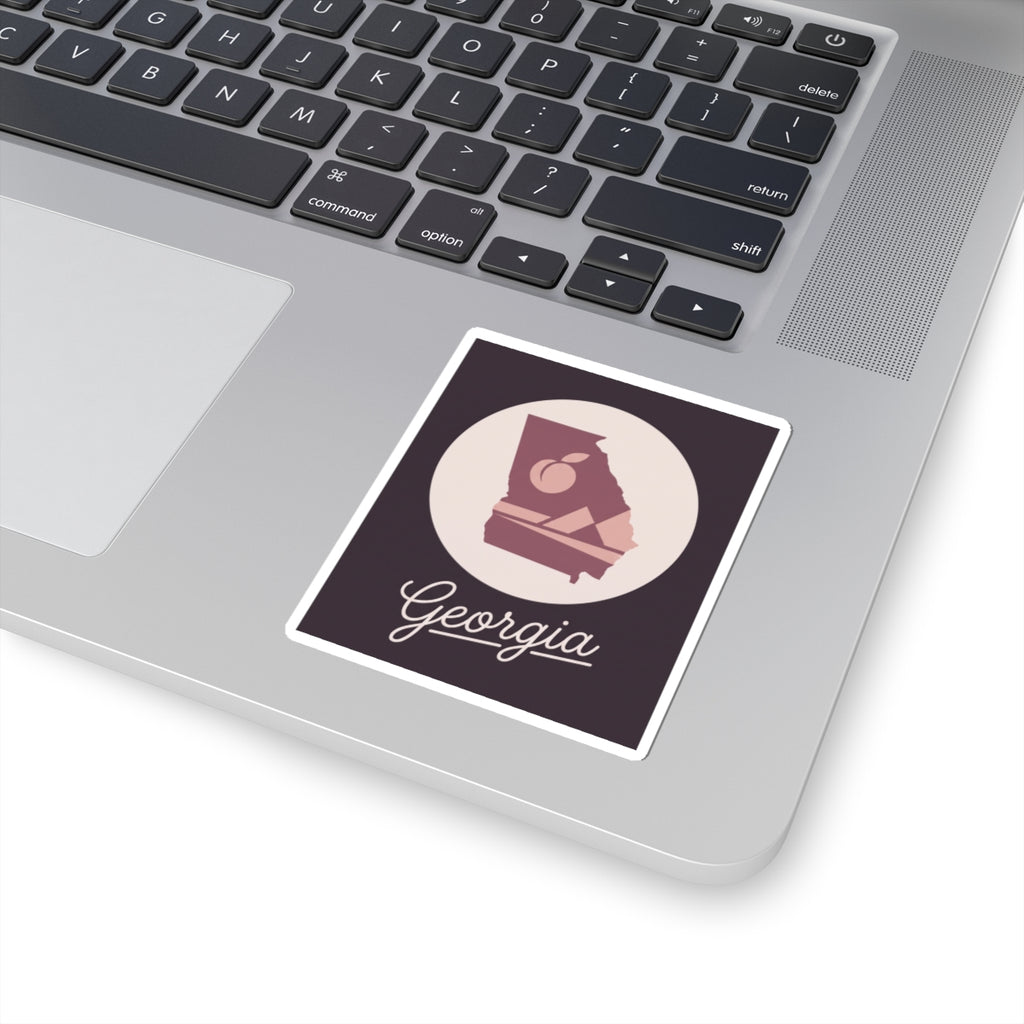 Mauve Georgia state silhouette vinyl decal on a laptop lid with cursive Georgia script
