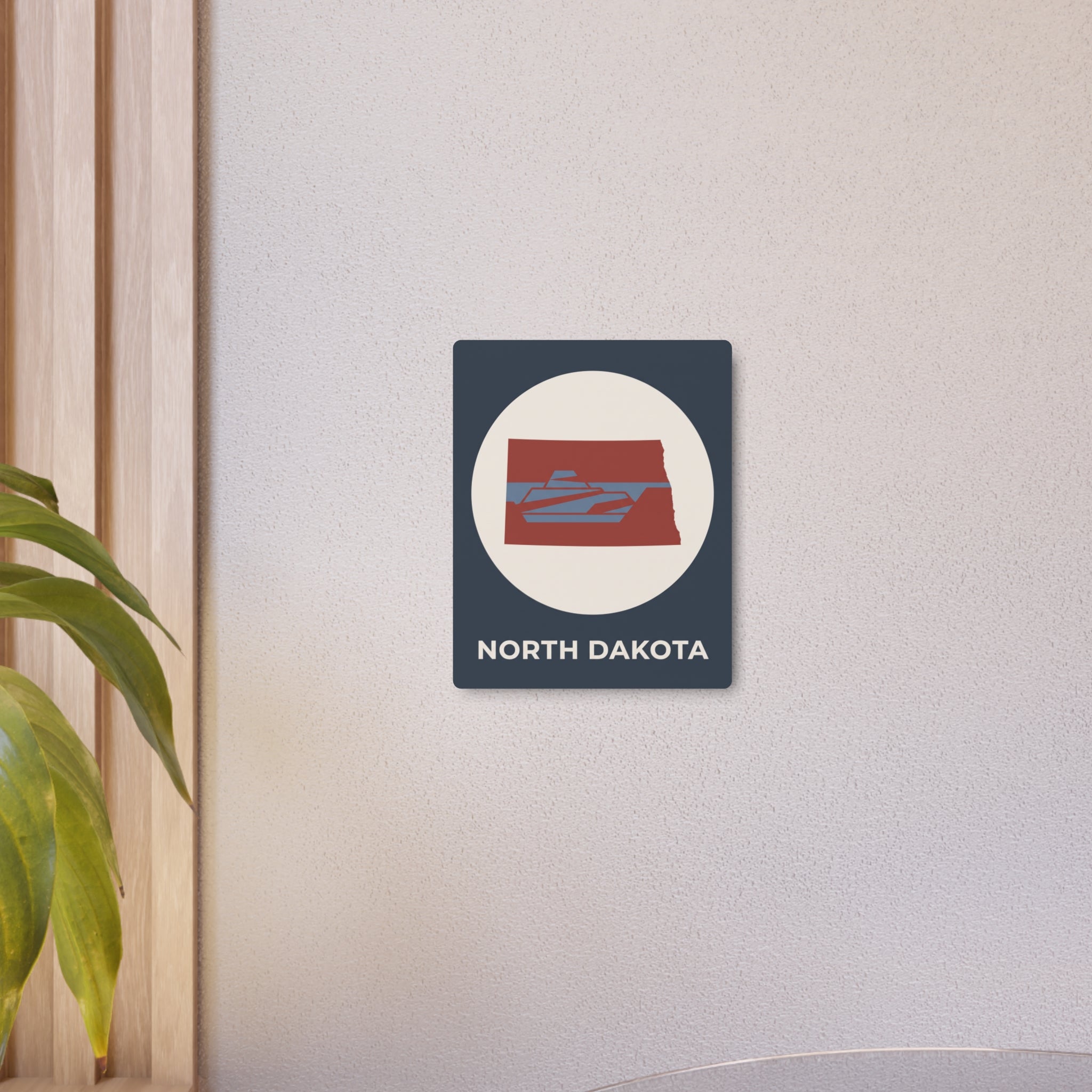 Small North Dakota metal wall sign on dark blue square panel with oval logo and text