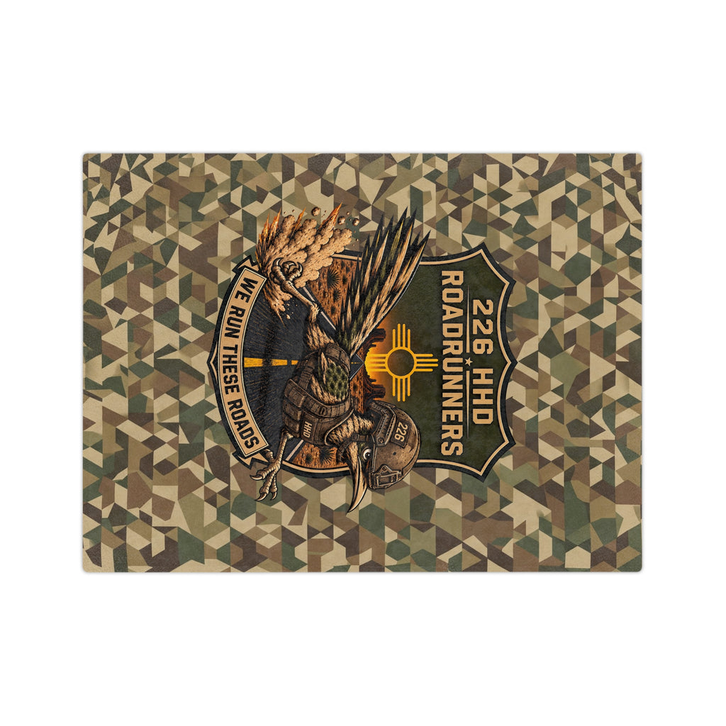 Microfiber blanket with green-brown geometric camo and central embroidered runner emblems