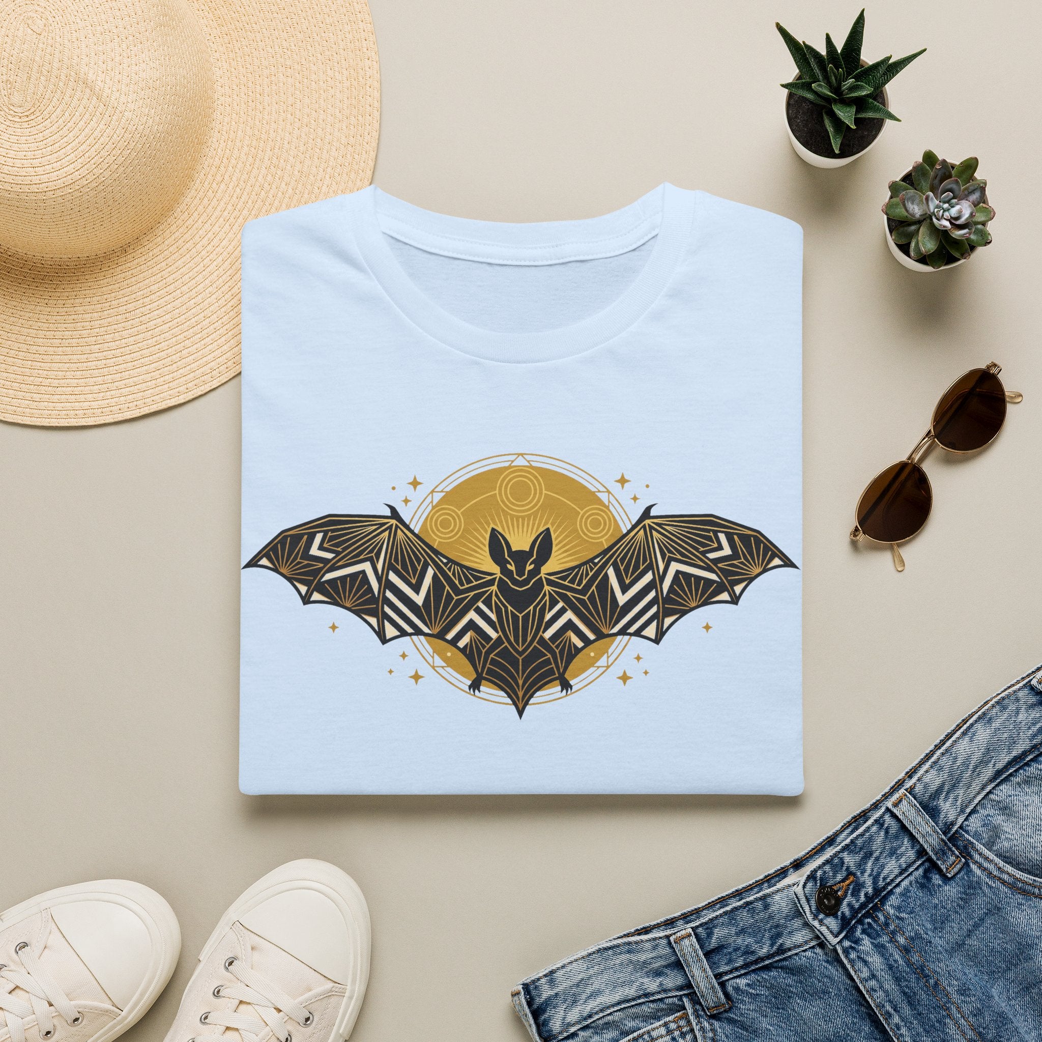 Light blue T-shirt with gold geometric bat and moon graphic