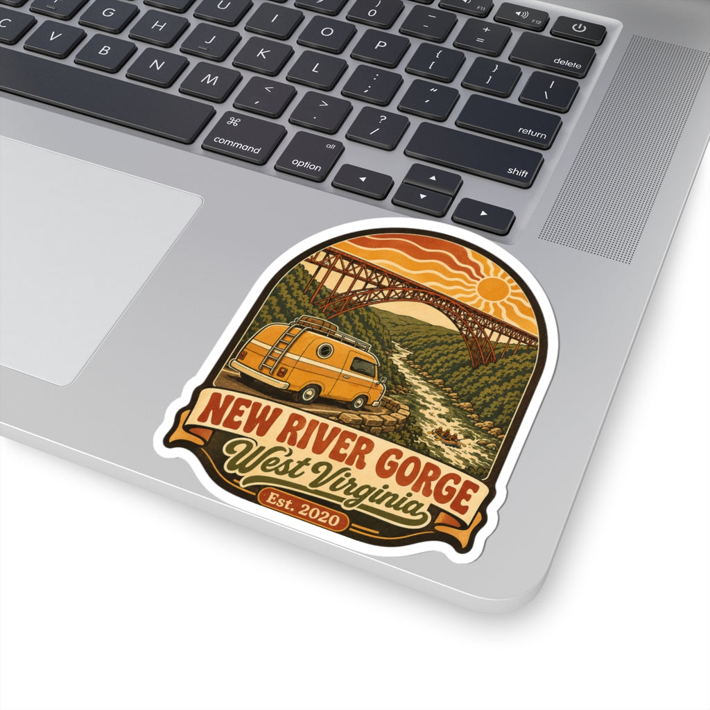 Die-cut travel sticker with yellow van driving past steel bridge and orange sunset lettering.