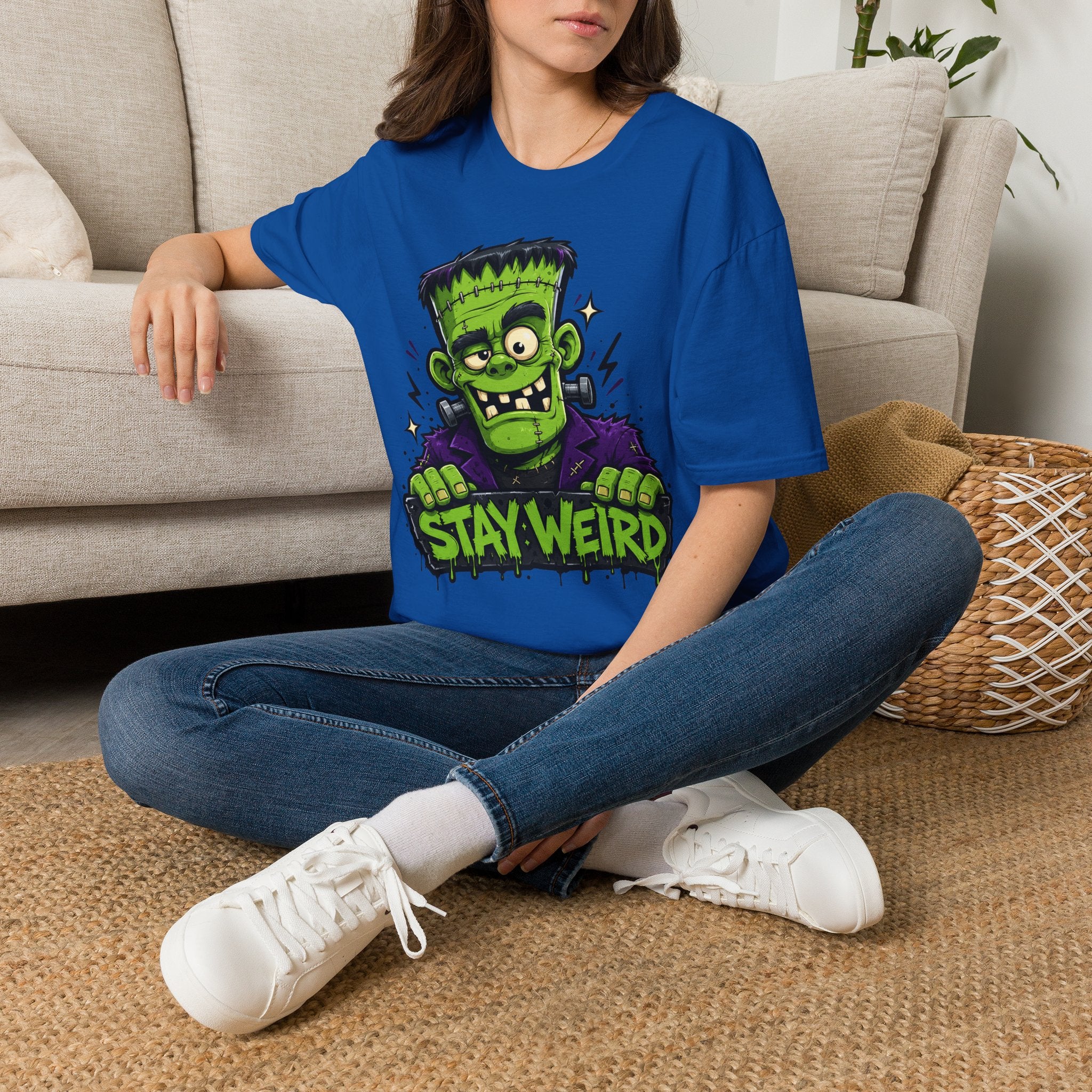 Royal blue crewneck T-shirt with green cartoon monster “STAY WEIRD” graphic
