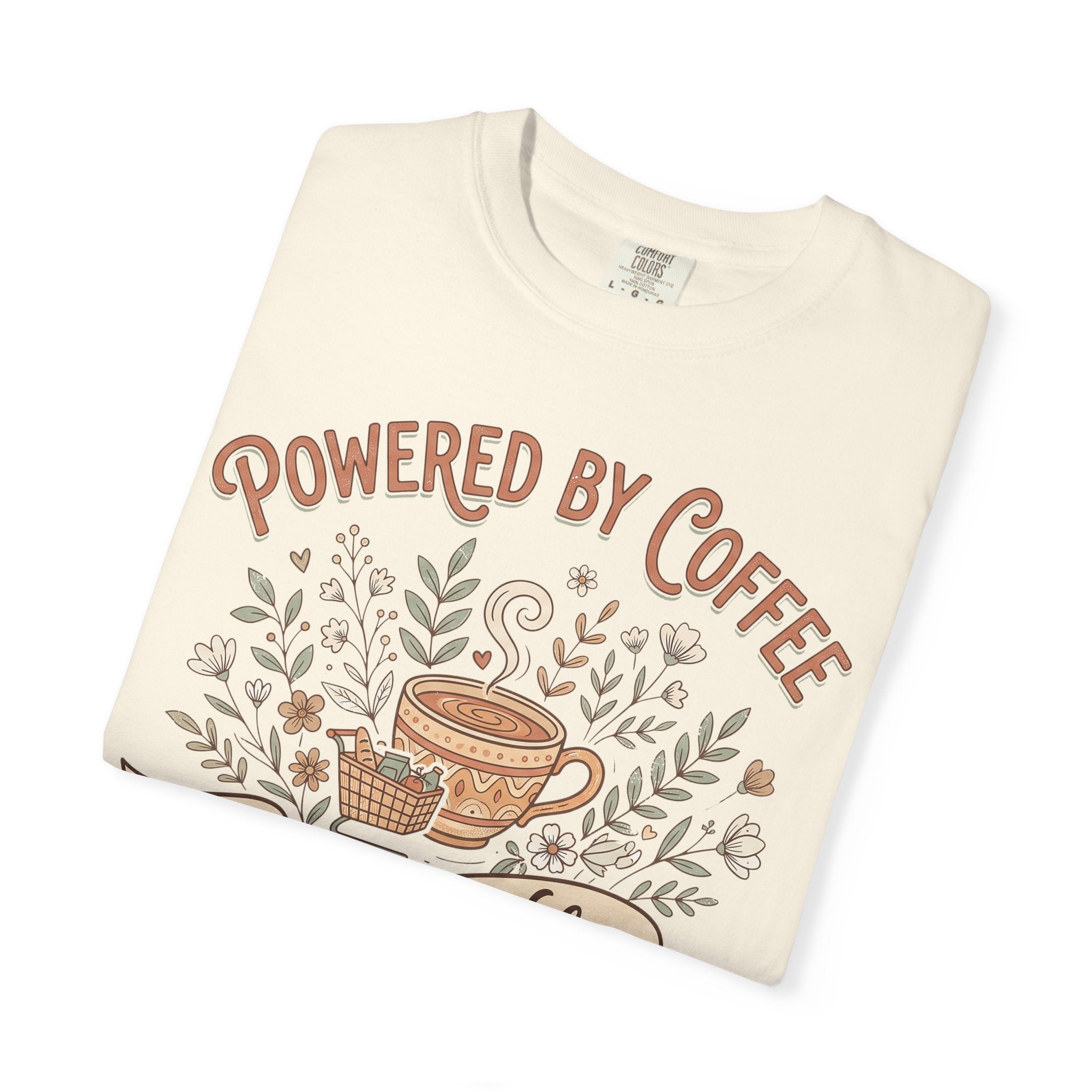 Cream T-shirt with 'Powered by Coffee' graphic, floral vines and coffee cup illustration