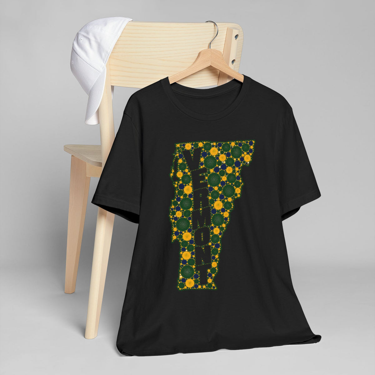 Black crew-neck T-shirt with floral Vermont map outline graphic in green and gold
