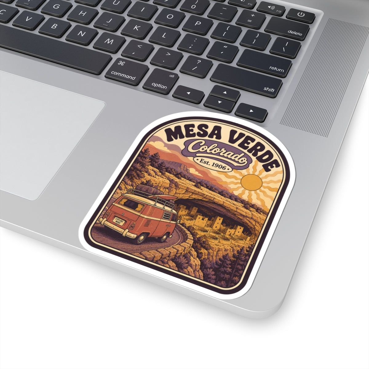 Sticker on a laptop: Mesa Verde Colorado badge with red camper van and desert landscape